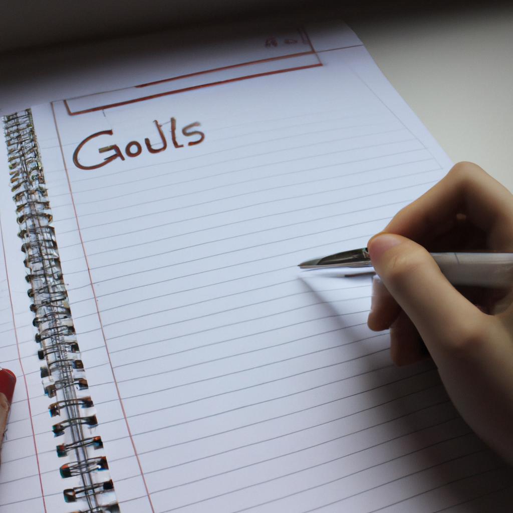 Person writing goals and schedule